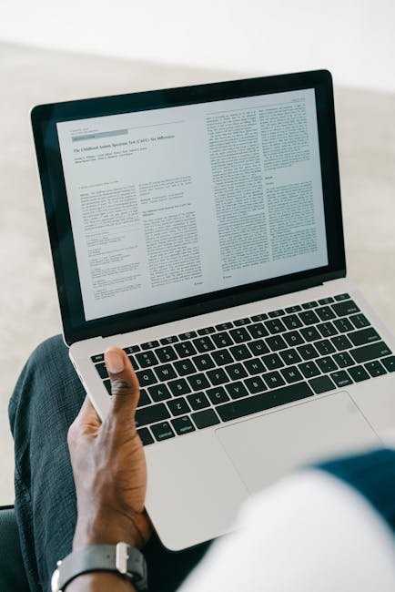 Person reading document on laptop screen, using AI to summarize content