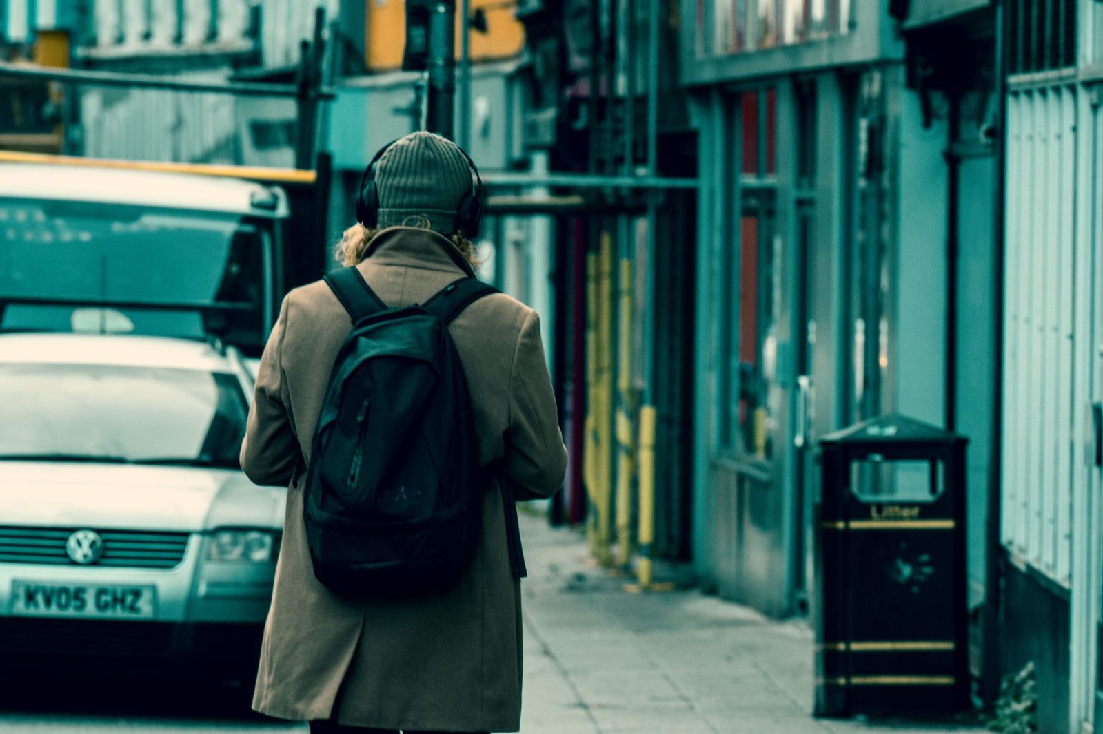 A person walking down a city street wearing headphones, talking hands-free with GPT-Live