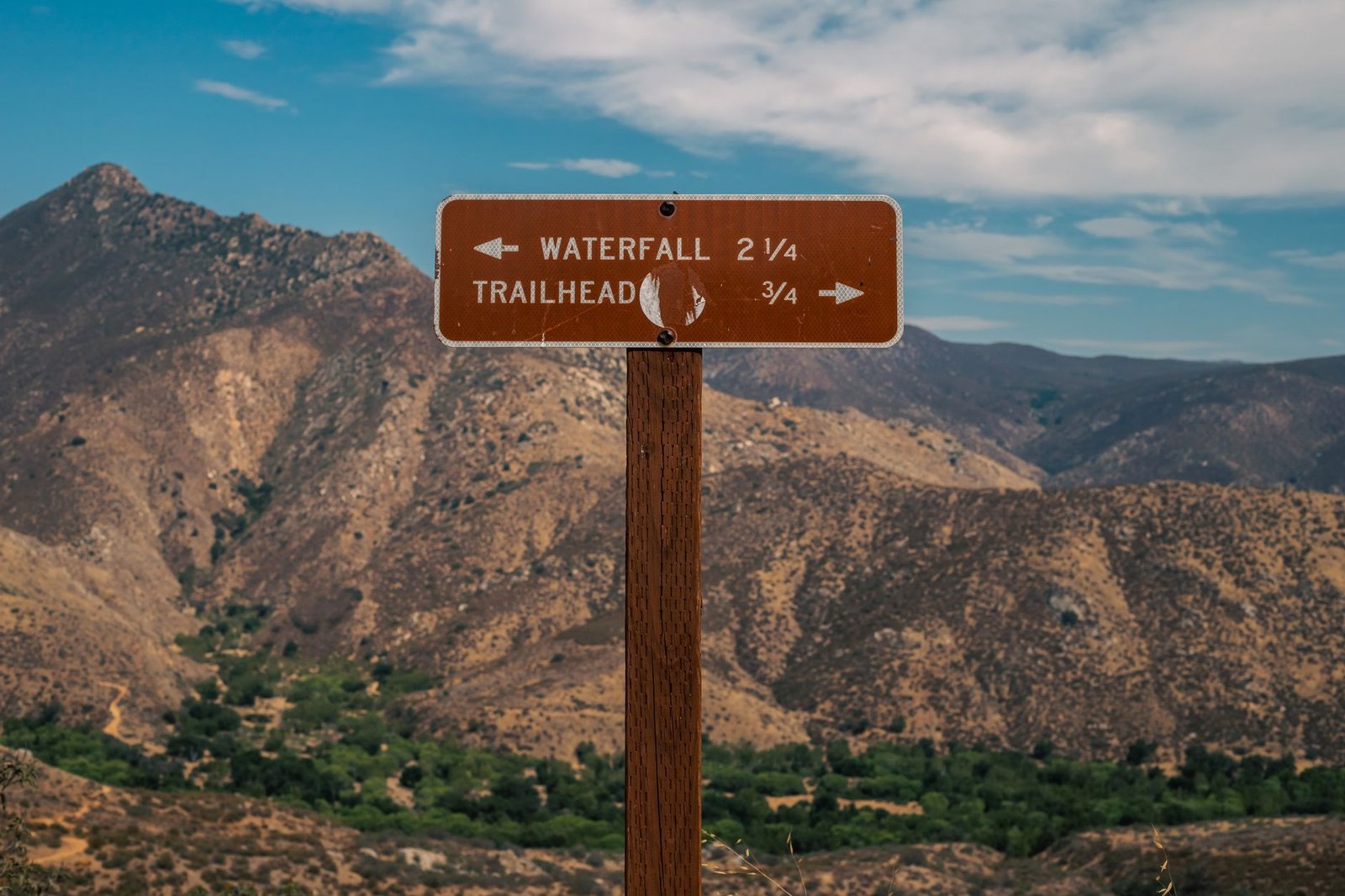 Wooden signpost showing trail directions, choosing which tool to use