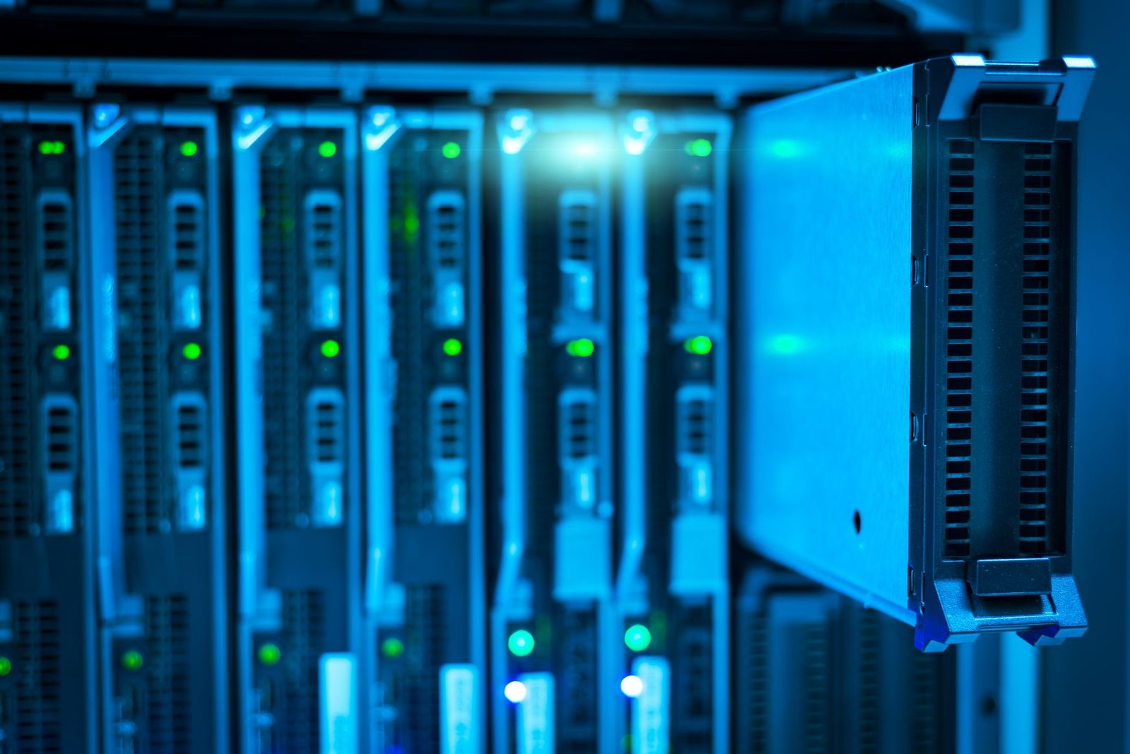 Rows of server racks in a data center, the machines driving AI electricity prices higher