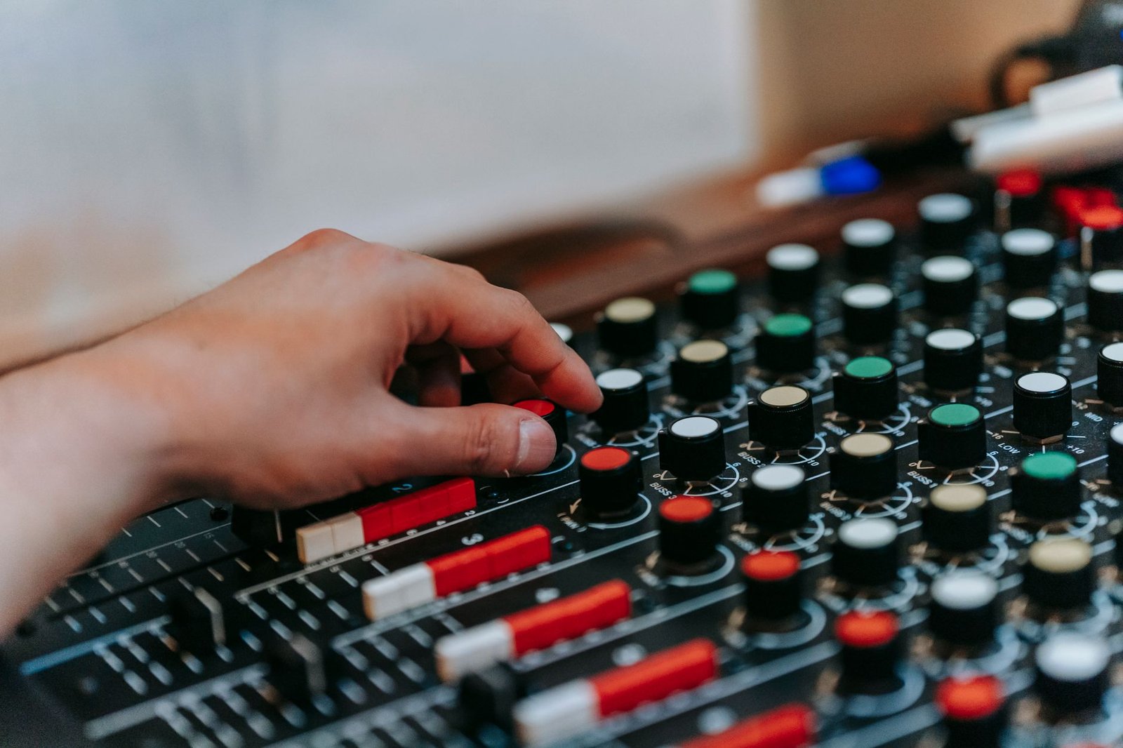 A hand adjusting control knobs, like the settings you use to control your ChatGPT memory