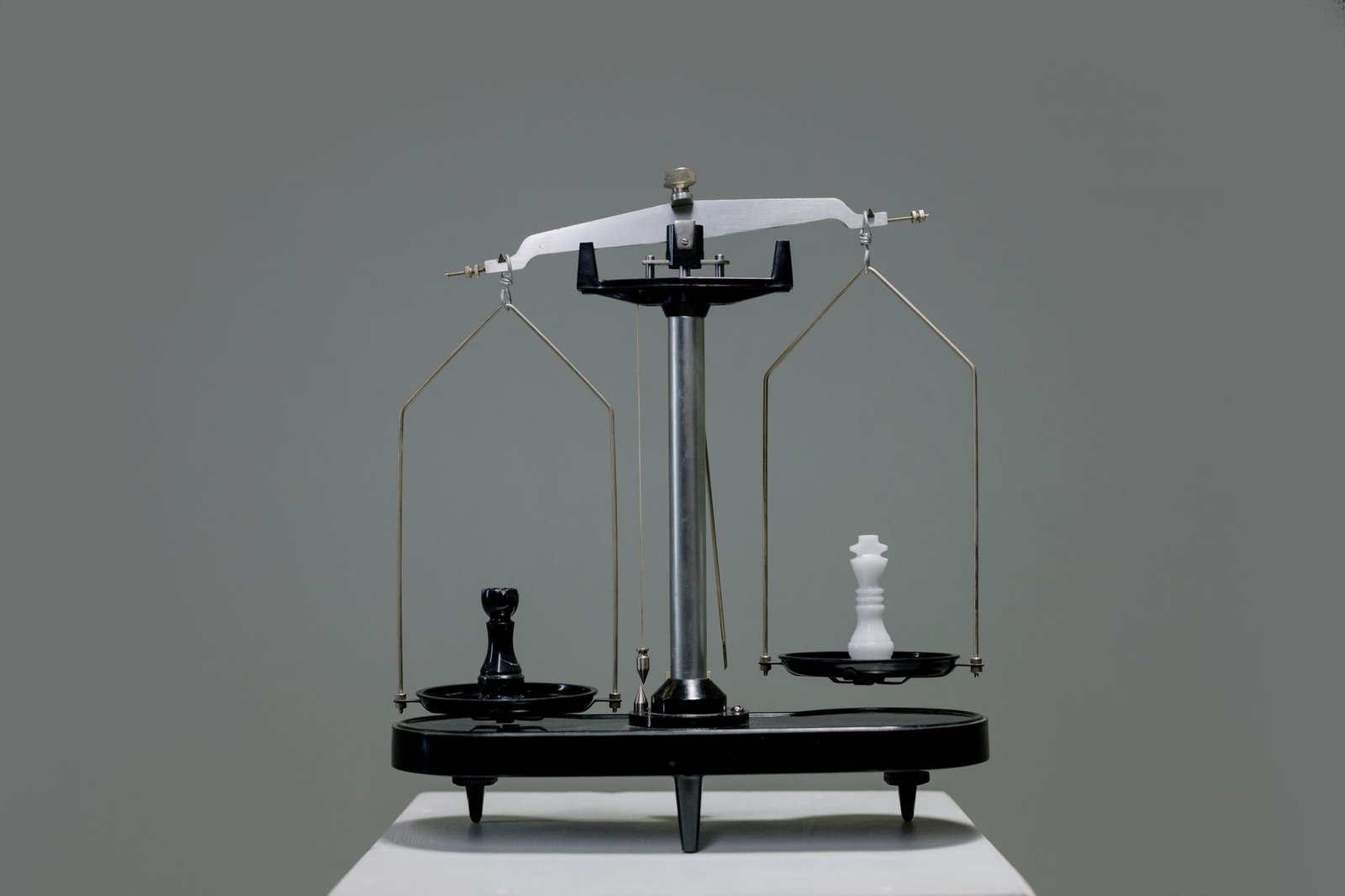 Chess pieces balanced evenly on a scale, like Fable 5 and GPT-5.6 Sol scoring nearly the same
