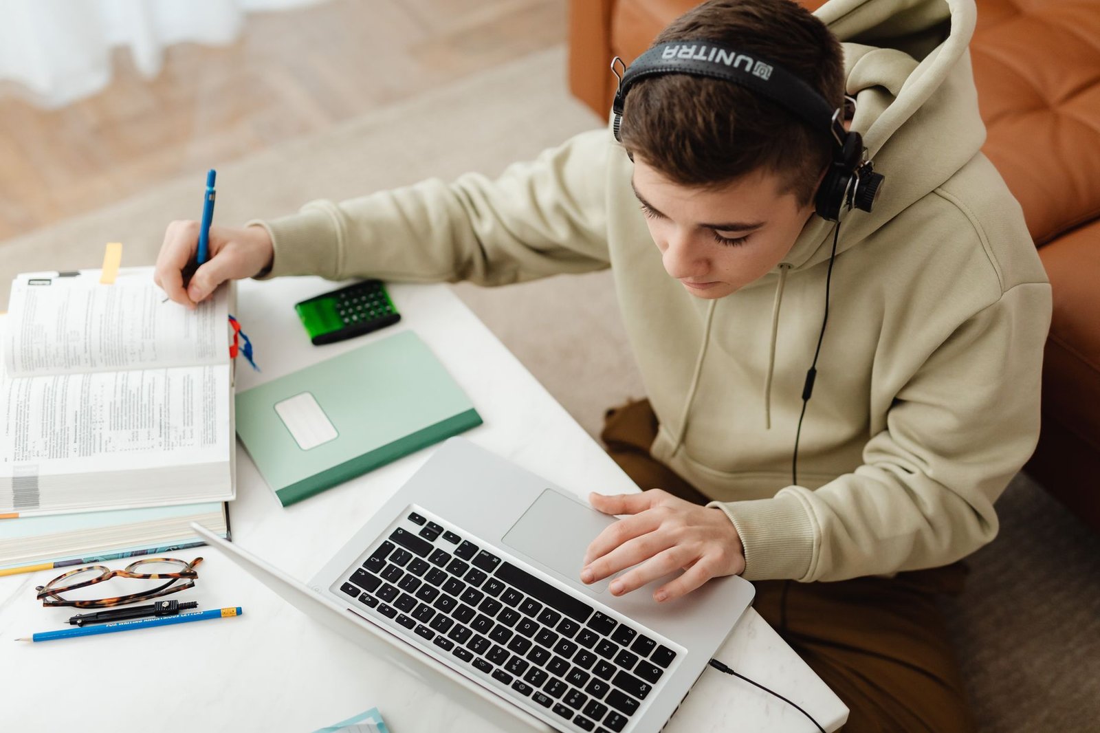 A teenager studying at home with a laptop and books, the use case ChatGPT for Teens study mode is built around