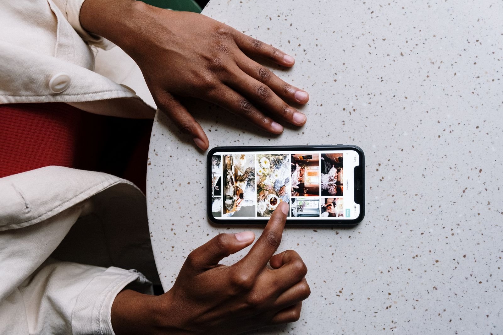 Hands scrolling a phone photo library, the mess Gemini Spark Google Photos is built to sort