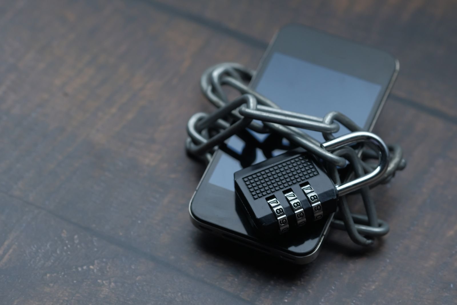 A smartphone wrapped in a chain and padlock, standing in for the question of whether Meta Muse is safe