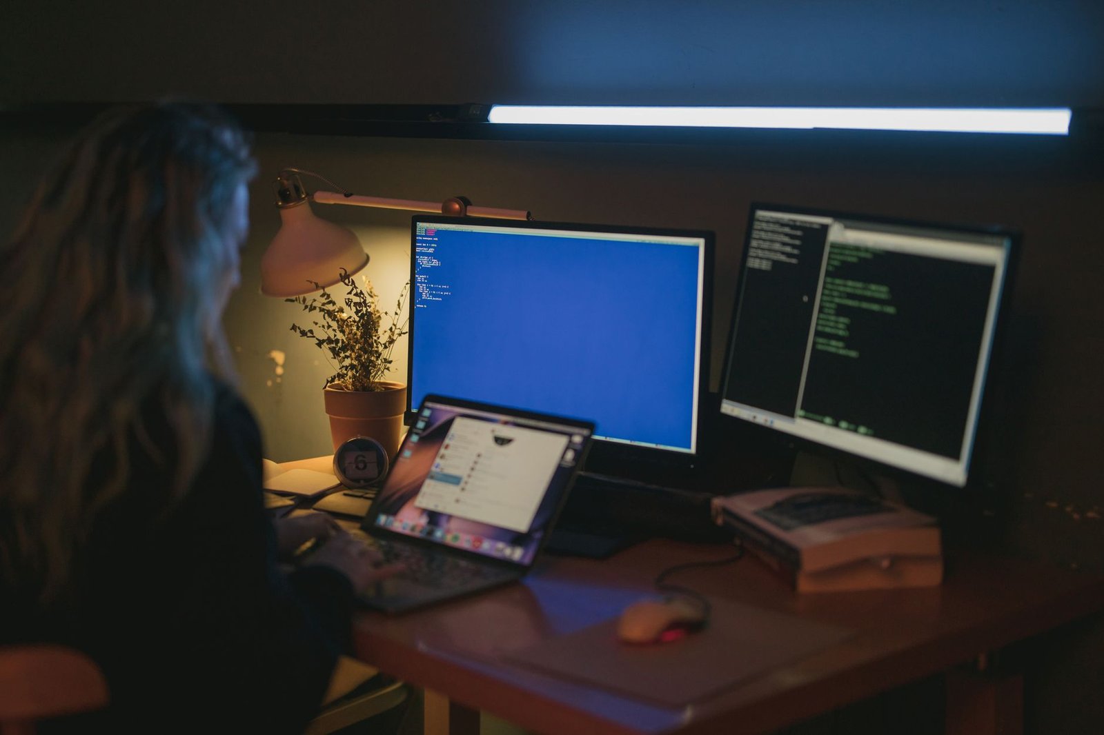 Person working across several screens at once in a home office